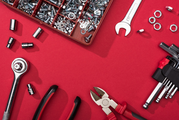 Frame of tool set with wrenches and hex keys on red background - 写真・画像