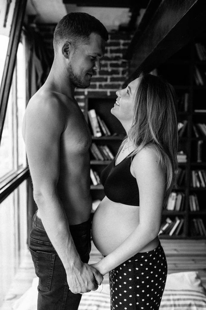 Young couple expecting baby standing together indoors - Photo, Image