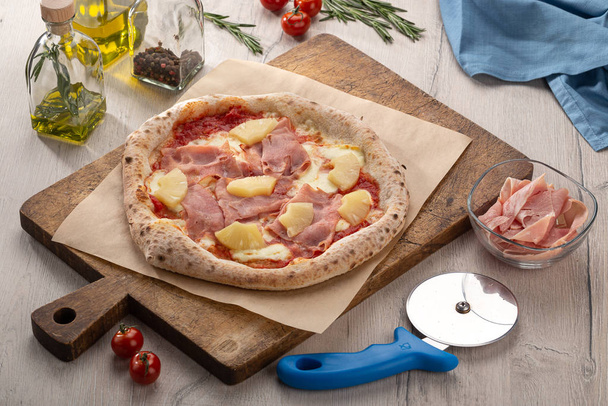 Delicious fresh pizza on table. pizza Hawaiian with pineapple and ham. Homemade delicious italian pizza on wooden table for dinner. Italian cuisine. - Photo, Image