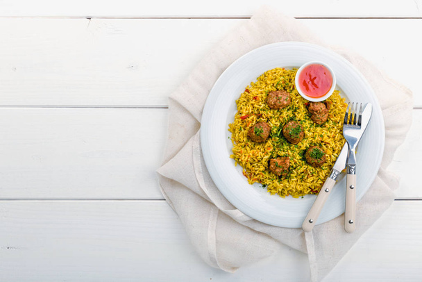 currys rizs húsgombóccal és friss fűszernövényekkel - Fotó, kép