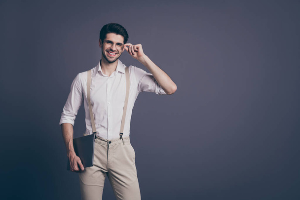 Portrait of positive cheerful guy company owner ready work decide solution touch his specs hold laptop wear good looking outfit isolated over grey color background - Fotografie, Obrázek