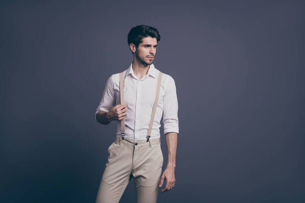Portrait of serious minded guy rich wealthy millionaire attract woman ideal man concept touch his suspenders stare copy space wear classy outfit isolated over grey color background - Fotó, kép