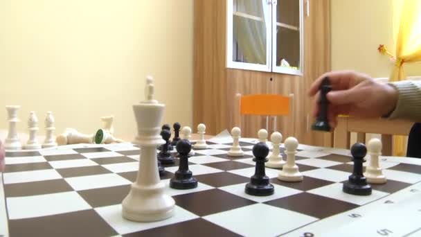 Teacher teaches a child to play chess. - Filmati, video