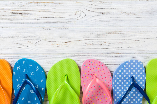 a lot of flip flop colored sandals, summer vacation on wooden ba - Photo, Image