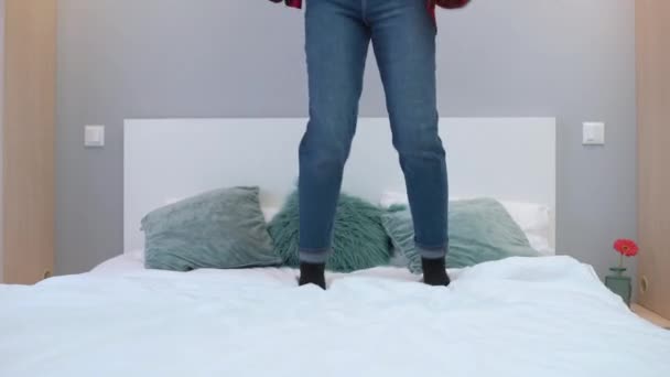 Young woman jumping on bed at home, comfortable mattress, happiness, freedom - Imágenes, Vídeo