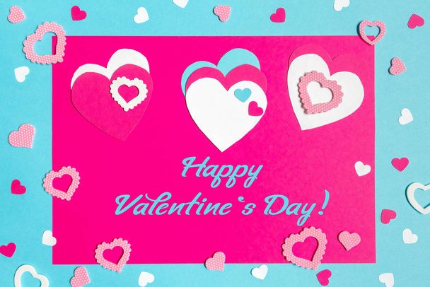 Valentine s Day greeting card. 14th of february. Happy Valentines Day Lettering with cut paper hearts on blue pink background with text  happy valentines day - Foto, immagini