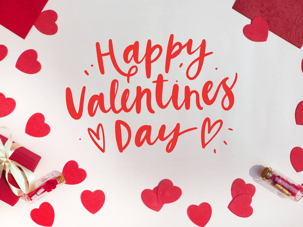 Tarjeta de San Valentín. Composición con regalos, corazones rojos en la superficie blanca. Vista superior. Espacio para texto
 - Foto, Imagen