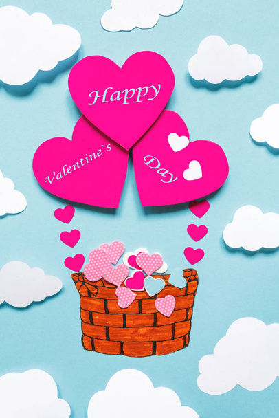 Happy Valentines Day greeting card design with basket of hearts. Handicraft, scrapbooking, handmade. Heart shape flying balloon and hearts decoration in blue background. - Foto, immagini