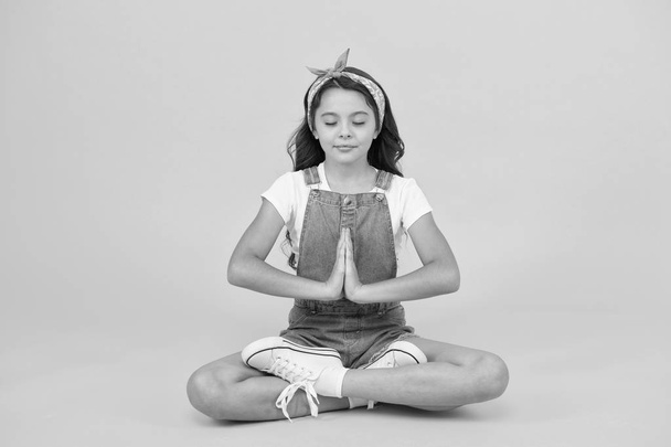 Inner calmness. Yoga meditation. Little child do meditation in healthy pose. Small girl enjoy meditation practice. Mindfulness meditation and concentration - Photo, Image