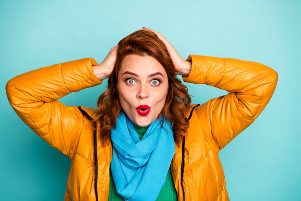 Closeup photo of funny lady addicted shopper look low black friday prices arms on head wear yellow overcoat blue scarf green turtleneck isolated teal color background - Foto, immagini