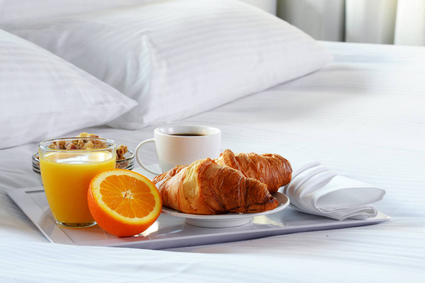 Breakfast in bed in hotel room. Accommodation. - Photo, Image