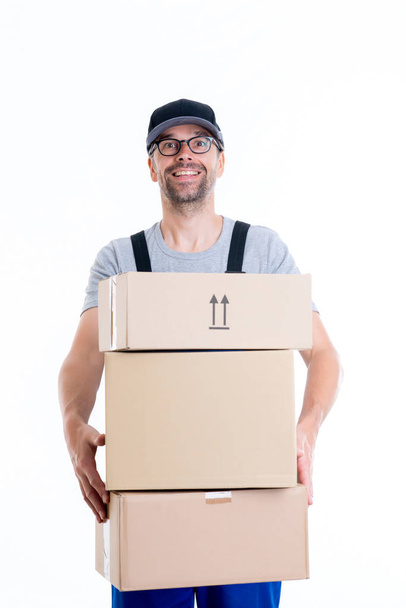 friendly postman with parcels in front of white background - Photo, Image