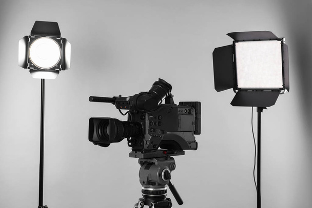 Professional video camera and lighting equipment on white background - Photo, Image