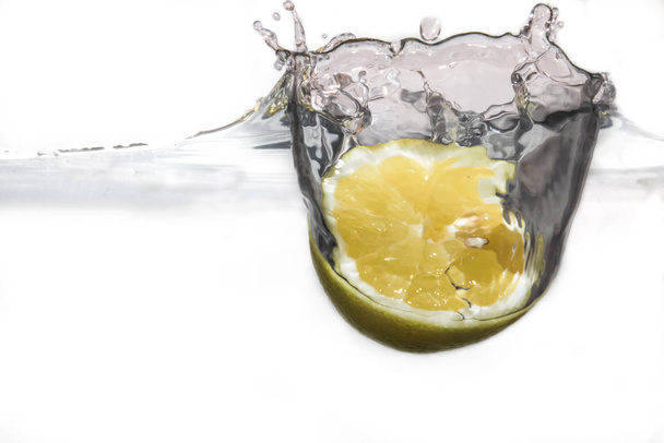 lemon falling into water splash - Fotó, kép