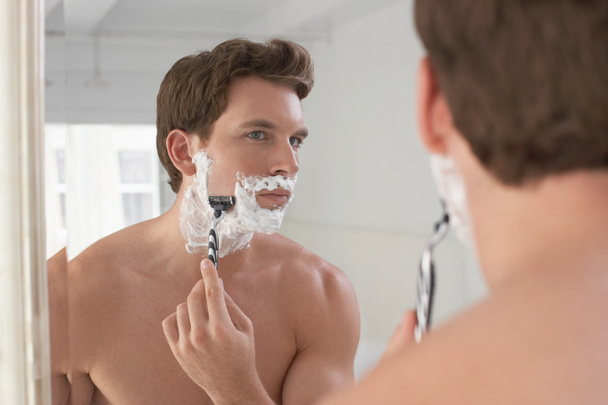 Man shaving in bathroom mirror - Valokuva, kuva