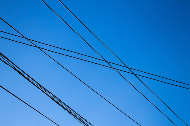 Electric wire isolated from blue sky background. - Fotografie, Obrázek
