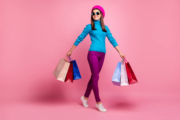 Full length body size view of her she nice-looking fashionable attractive lovely pretty addicted cheerful cheery girl carrying bags spending free time isolated over pink pastel color background - Zdjęcie, obraz