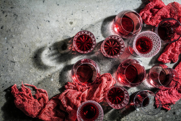 close-up view of glasses of red wine on grey background - Фото, изображение