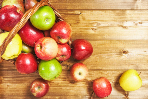 Basket of apple fruits on wooden background. Healthy eating and dieting concept. Copy space. Top view - Фото, изображение