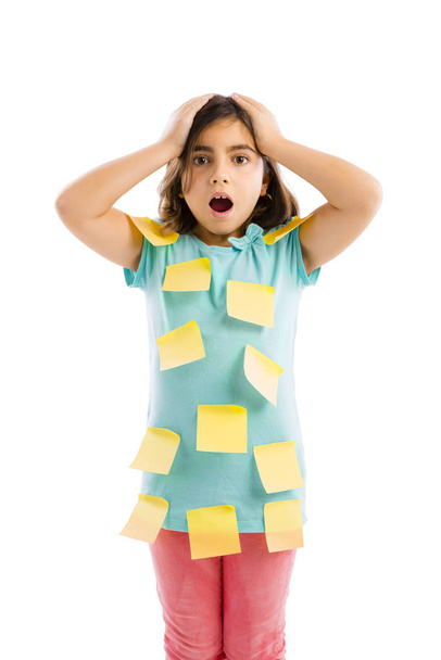 Stressed young girl with yellow notes sticked all over the body - Foto, afbeelding