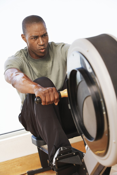 Man working out on Rowing Machine - Photo, image