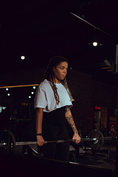 athletic african american woman exercising with barbell in gym  - Fotoğraf, Görsel