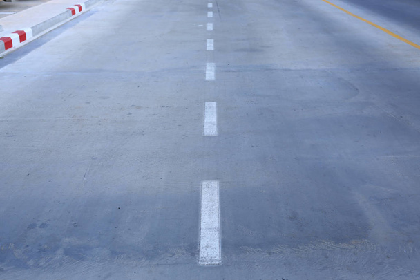 Concrete road with a white markings lane. - Фото, изображение