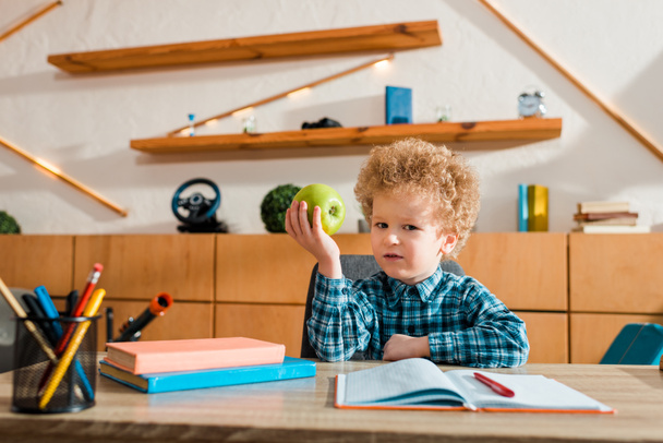 cute smart kid holding ripe apple and looking at camera  - Foto, Imagem