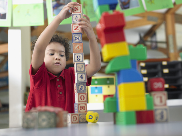 Boy playing with alphabet blocks - Фото, изображение