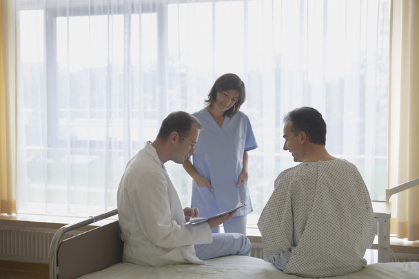 Doctor and Nurse Consulting with Patient - Valokuva, kuva