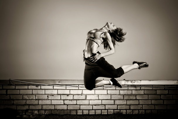 Girl jumping on the roof - Фото, изображение