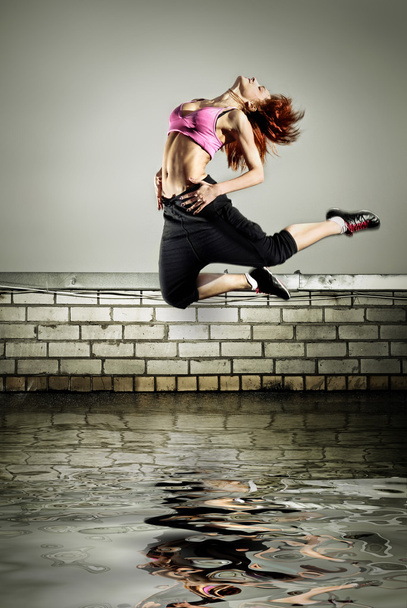 Girl jumping on the roof - Фото, изображение