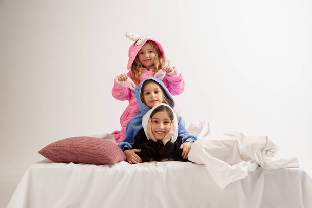 Children in soft warm pajamas having party colored bright playing at home - Fotografie, Obrázek