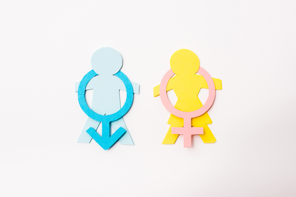 top view of colorful paper cut people near gender signs isolated on white, sexual equality concept  - Fotó, kép
