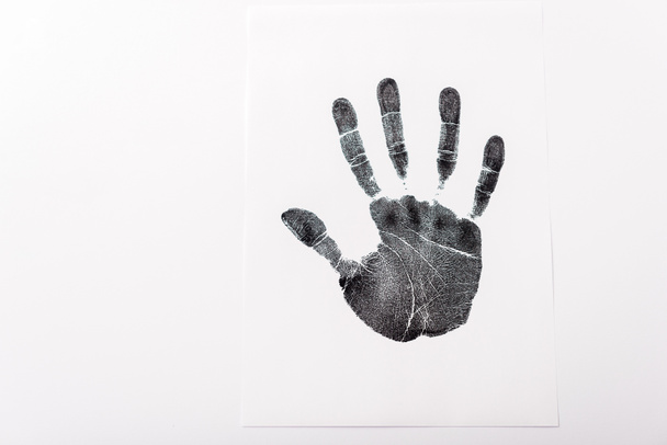πάνω όψη του μαύρου αποτυπώματος του χεριού που απομονώνεται στο λευκό, με την έννοια του χώρου αντιγραφής των ανθρωπίνων δικαιωμάτων  - Φωτογραφία, εικόνα