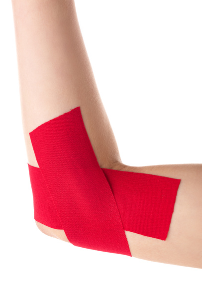 Cropped view of female cubit with kinesiology tapes isolated on white - Photo, Image
