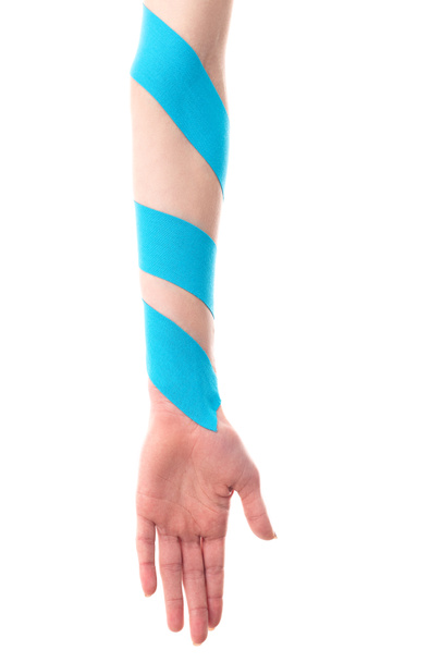 Cropped view of female hand with kinesiology tapes isolated on white - Фото, изображение