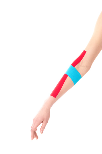 Cropped view of kinesiology tapes on woman hand isolated on white - Фото, зображення