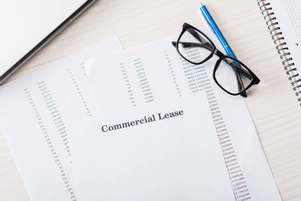 top view of document with commercial lease lettering near glasses on desk  - Photo, Image