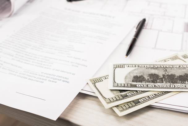 selective focus of dollar banknotes near documents and pen on desk  - Photo, Image