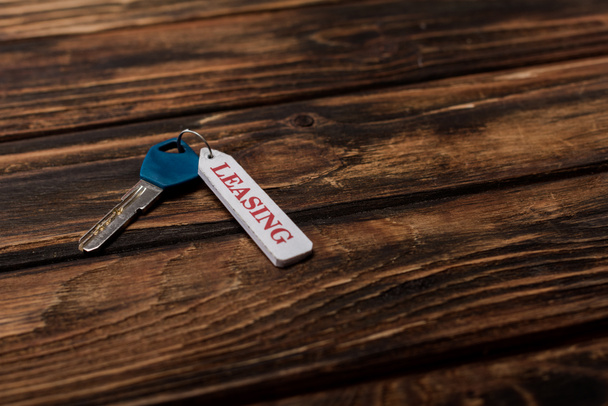  key with leasing lettering on wooden surface  - Photo, Image