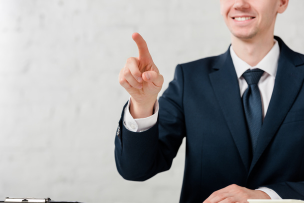 cropped view of happy realtor pointing with finger on white, leasing concept  - Фото, зображення