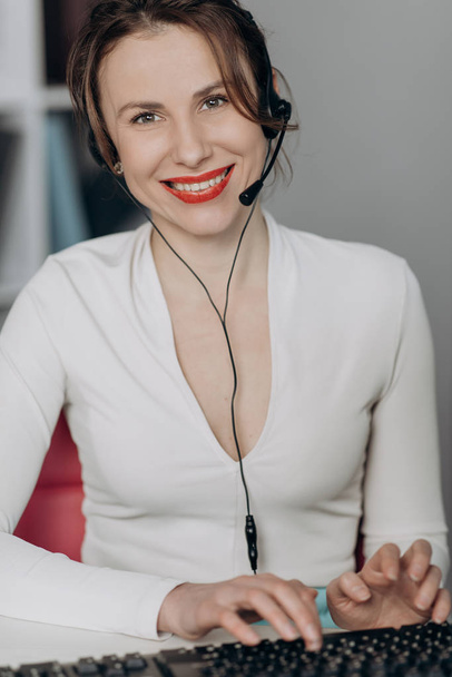 Happy woman in headphones speaking by webcam at webinar training look at laptop make notes, girl student talking by video conference call, online teacher teaching consulting client e-coaching concept. - Foto, afbeelding