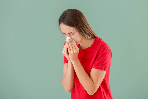 Young woman suffering from allergy on color background - Photo, Image