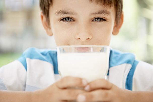 boy holding glass of milk  - Фото, зображення