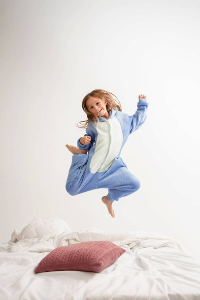 Little girl in soft warm pajama having party colored bright playing at home - Foto, Bild