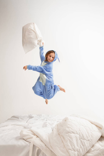 Little girl in soft warm pajama having party colored bright playing at home - Foto, Imagem