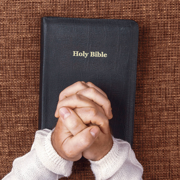 las manos dobladas del hombre en la santa biblia
 - Foto, Imagen