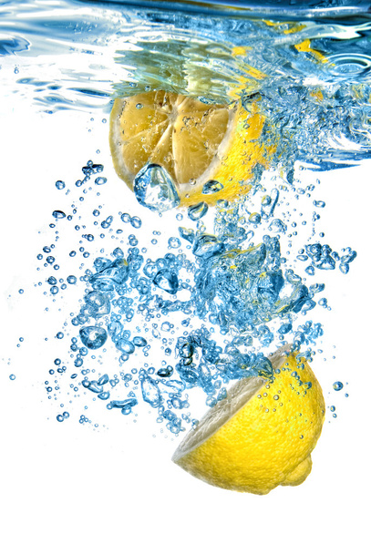 Fresh lemon dropped into water with bubbles isolated on white - Foto, Bild