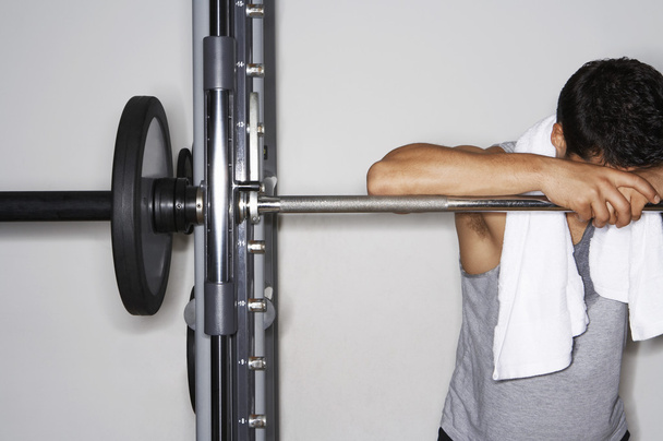 Man resting on barbell - Photo, Image